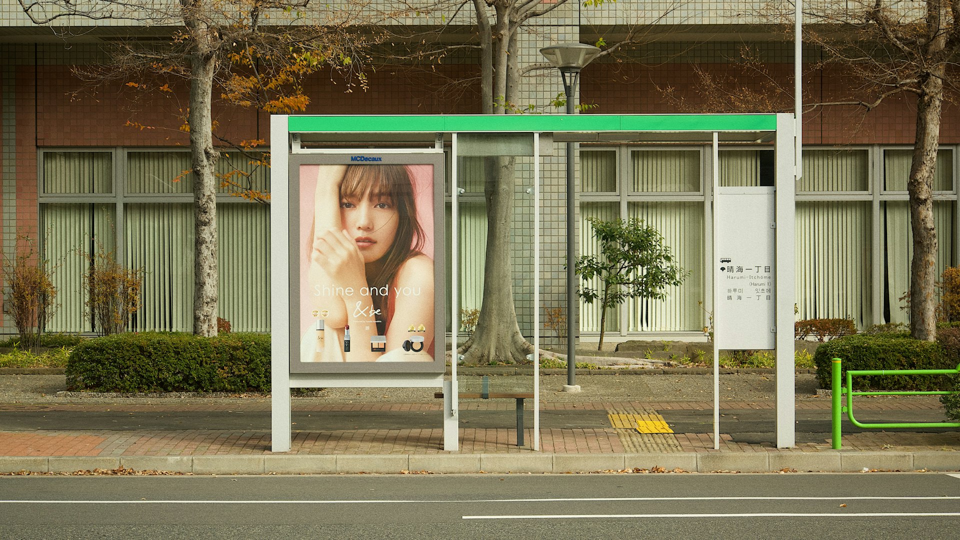 a bus stop with a billboard on the side of it